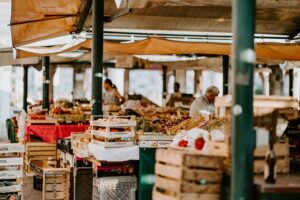 A visit to a local farmers' market displays a variety of fresh fruits and vegetables in colorful stalls.
